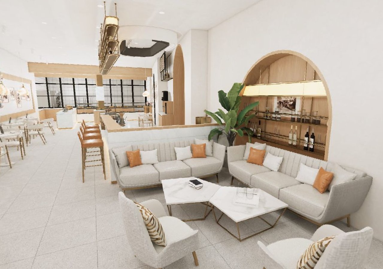 Bright airy café with lounge seating, marble tables and arched alcove
