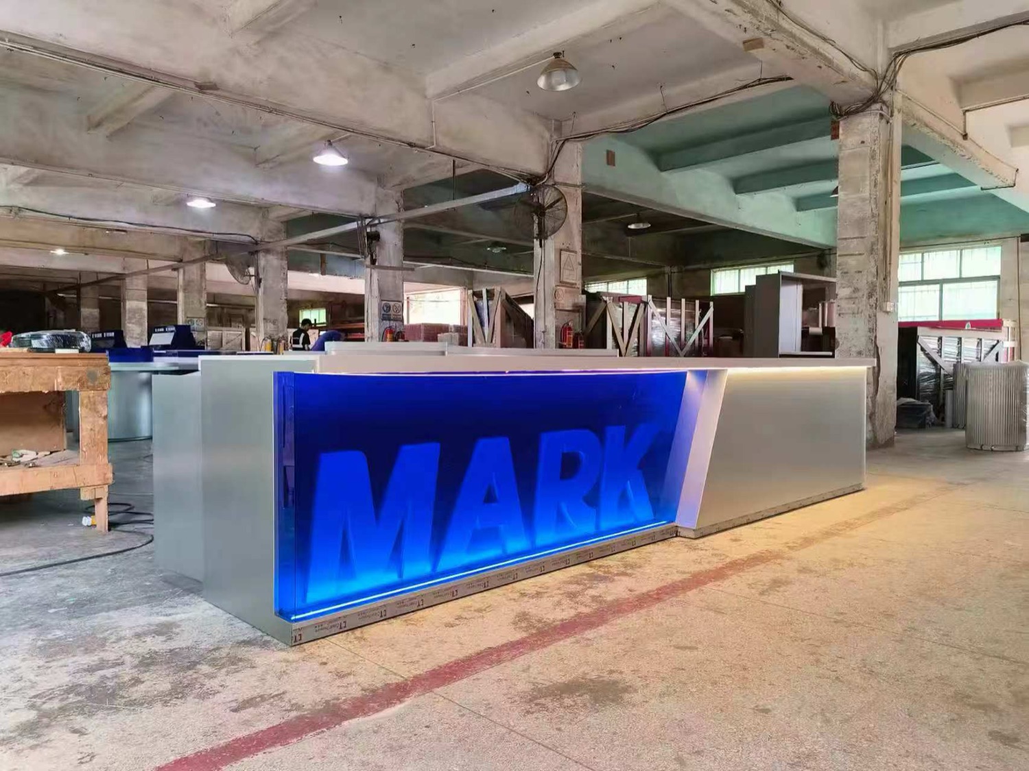 Illuminated retail counter fixture standing on the factory floor
