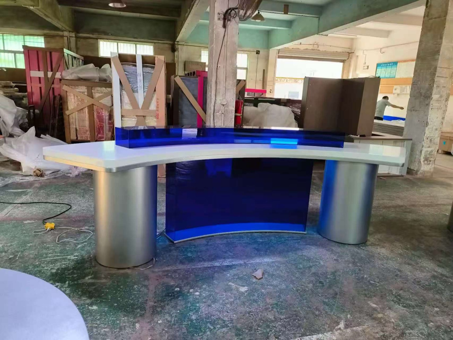 Illuminated curved retail counter built on the factory floor