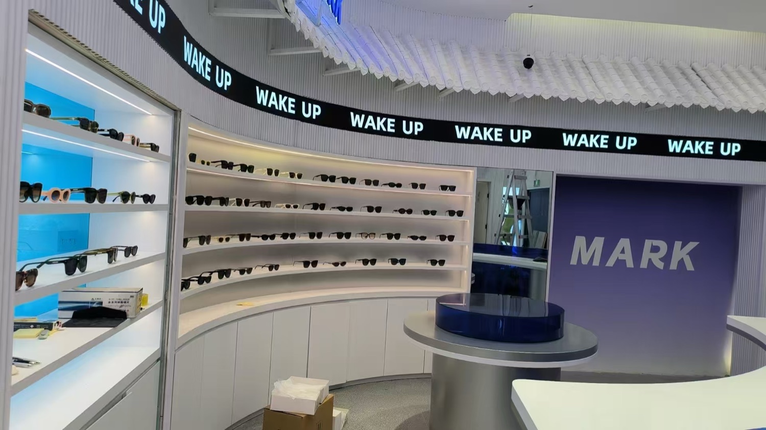 Finished illuminated eyewear display wall built in the facility