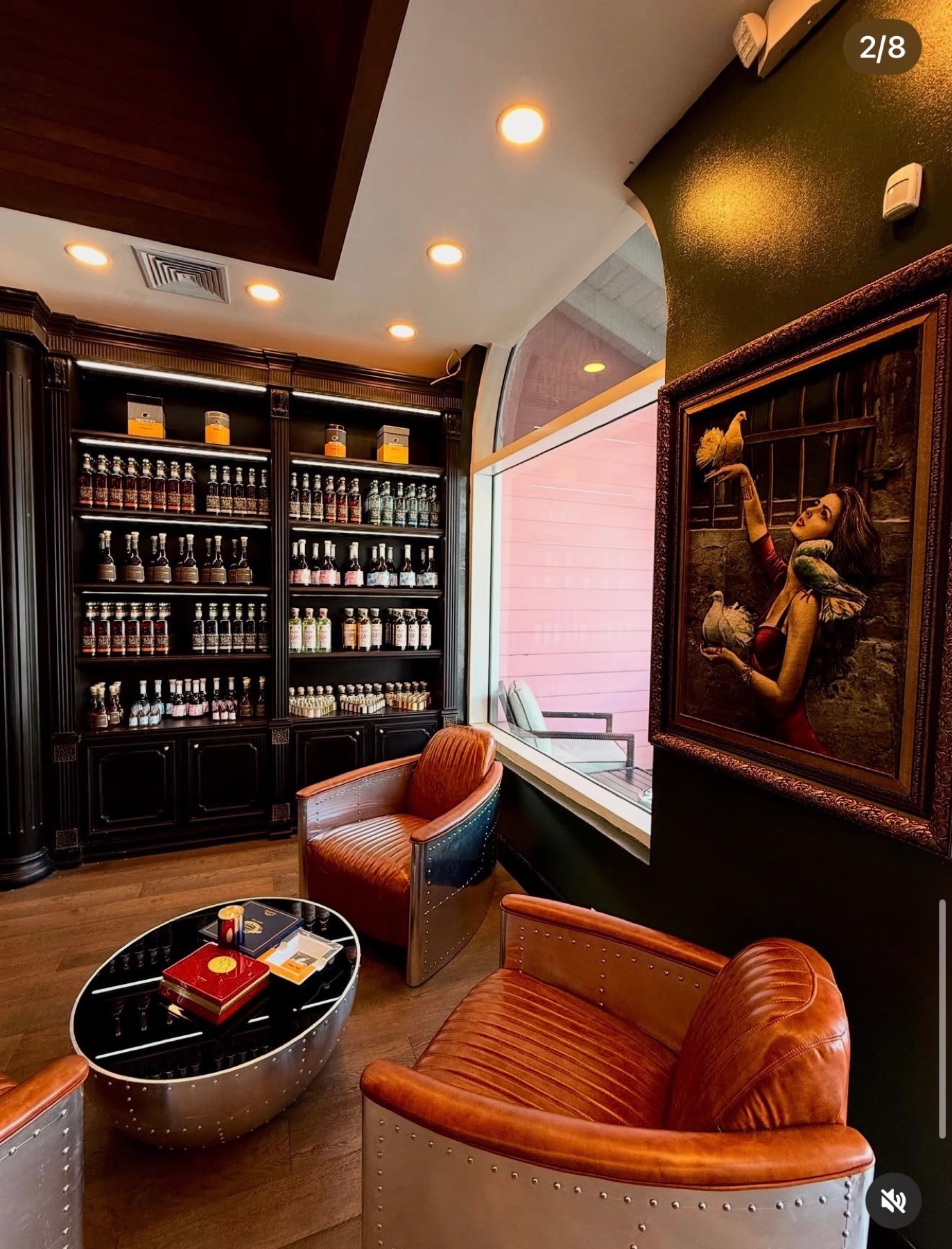 Private cigar lounge with leather club chairs and dark cabinetry